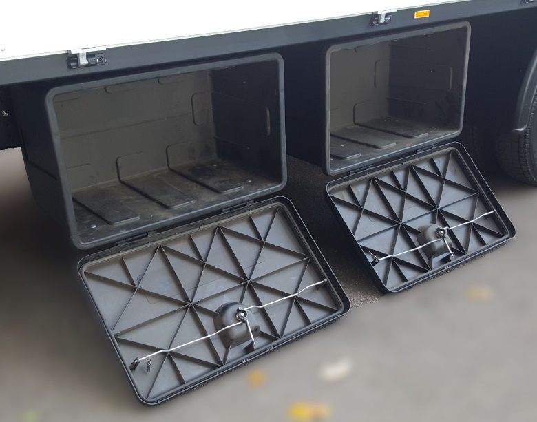 Two open storage boxes mounted under the body