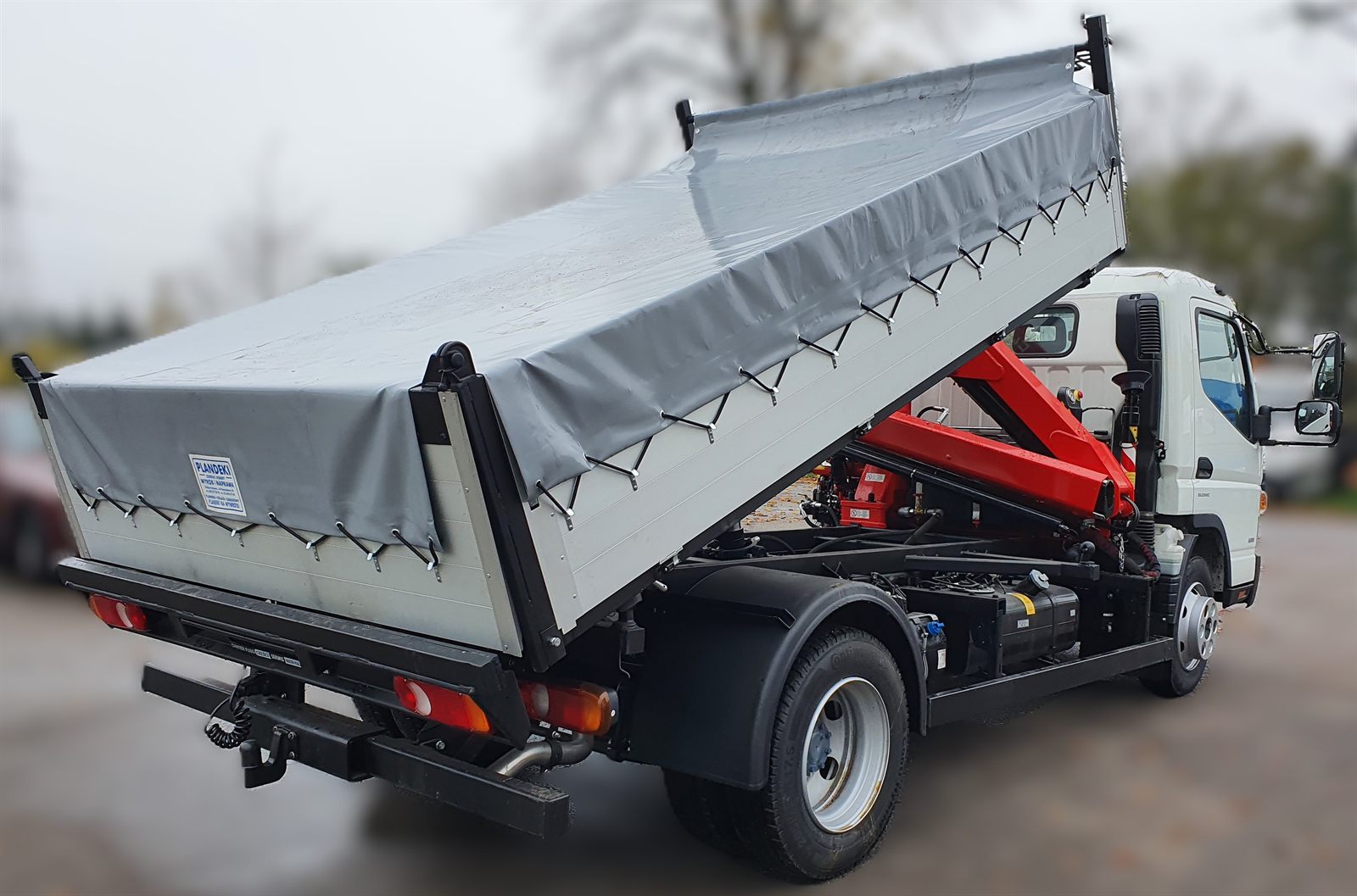 Tipper with a tarpaulin cover protecting the load, on a Mitsubishi Fuso Canter