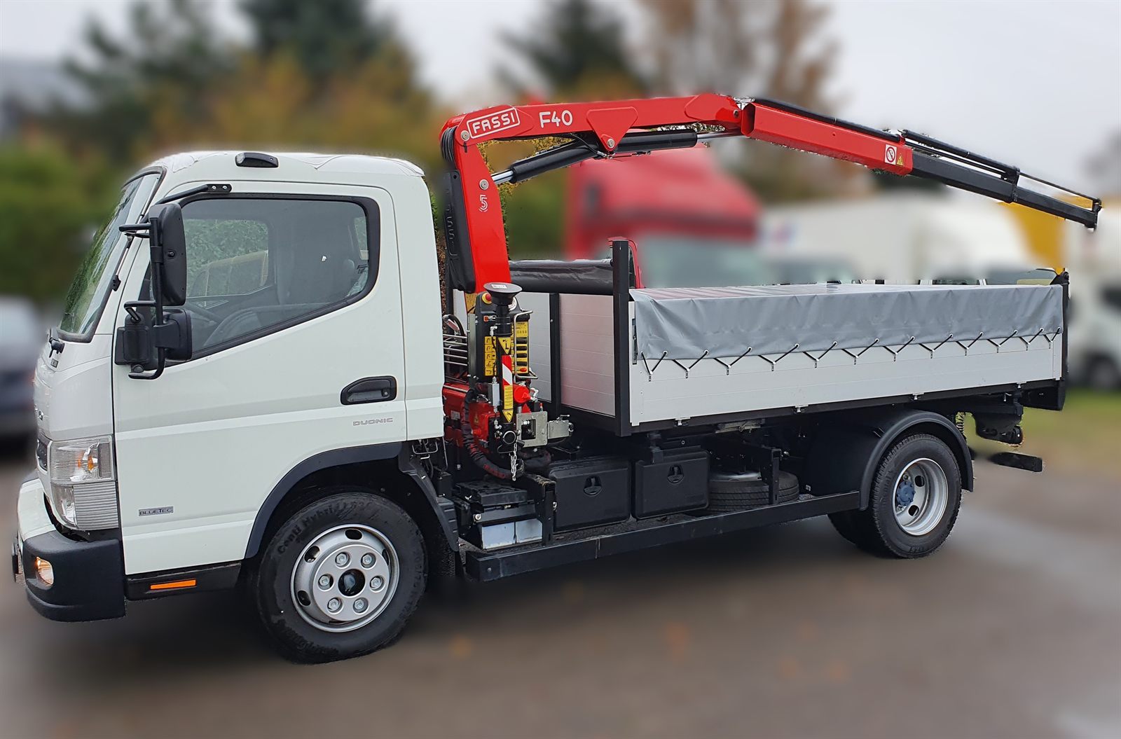 Fassi F40 crane mounted behind the cab of a tipper on a Fuso Canter 9C18 chassis