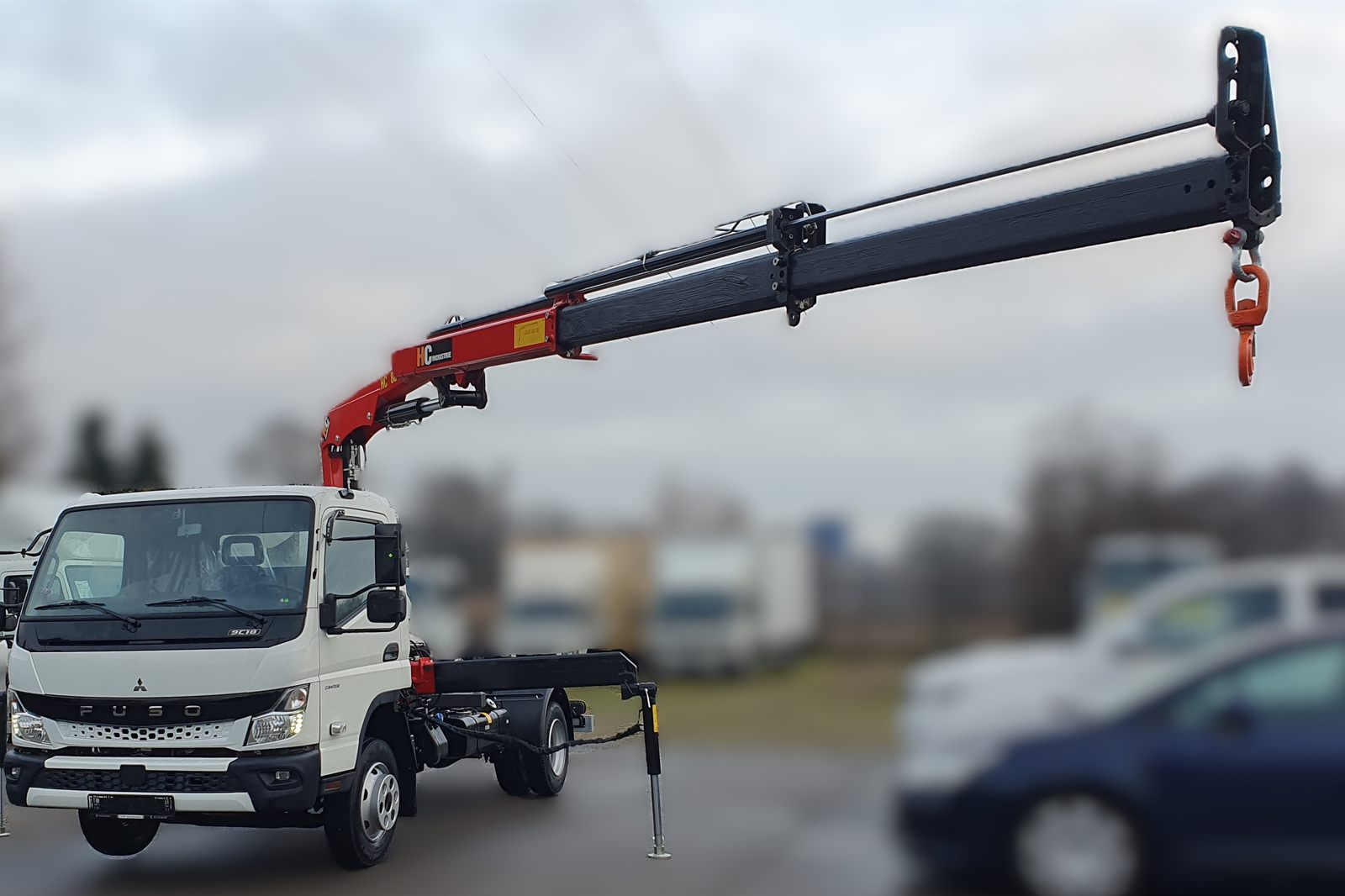 HC 80 crane with the boom extended over a Fuso Canter 9C18 platform
